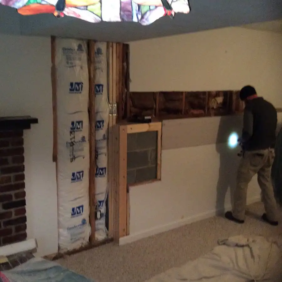 Restoration technician inspecting water damage in Ashtabula